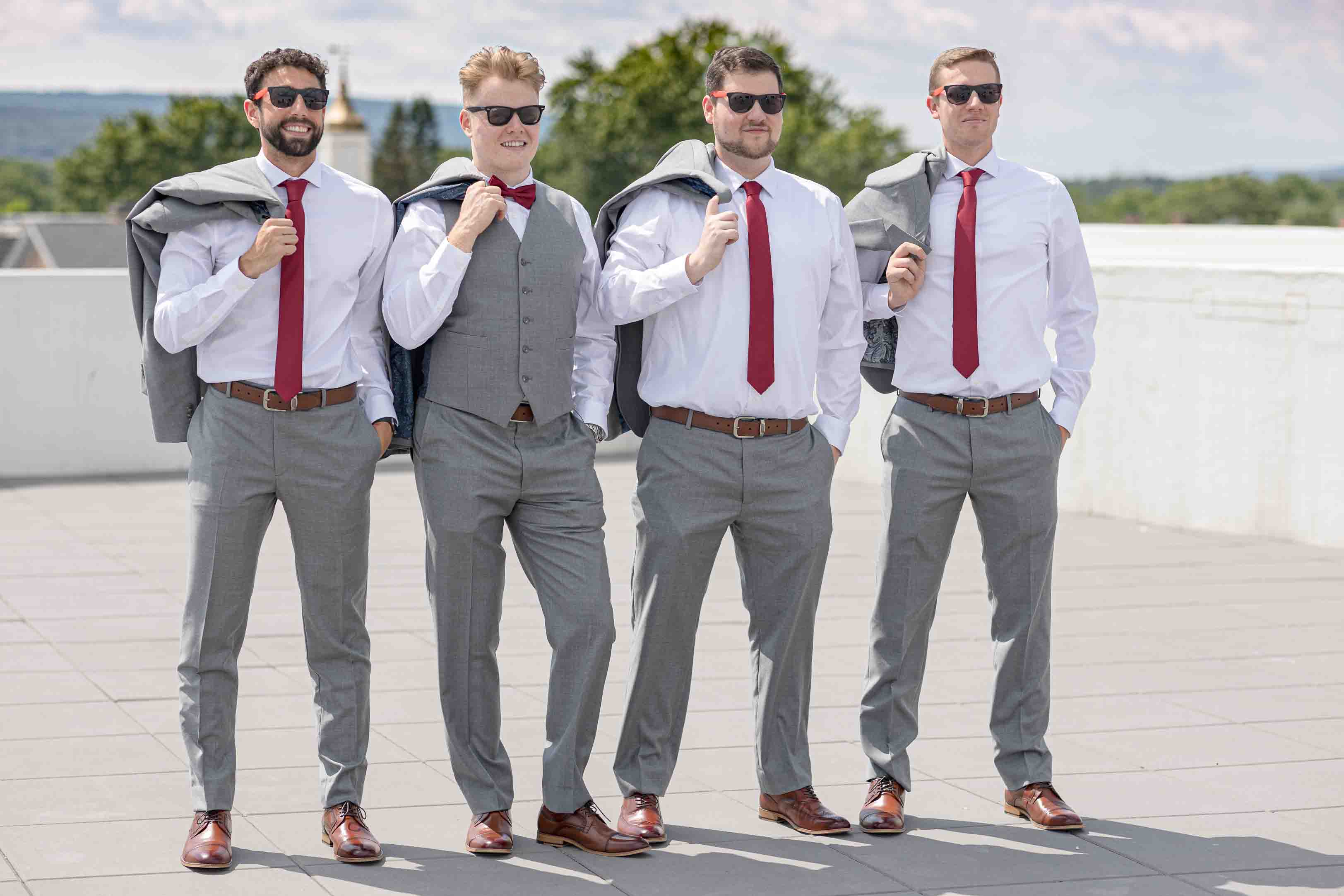 Groom and groomsmen pre-wedding looking cool, wearing matching sunglasses. Rooftop Frog Alley Brewing in Schenectady, NY. Albany Wedding Photographer. Groom Power Poses.