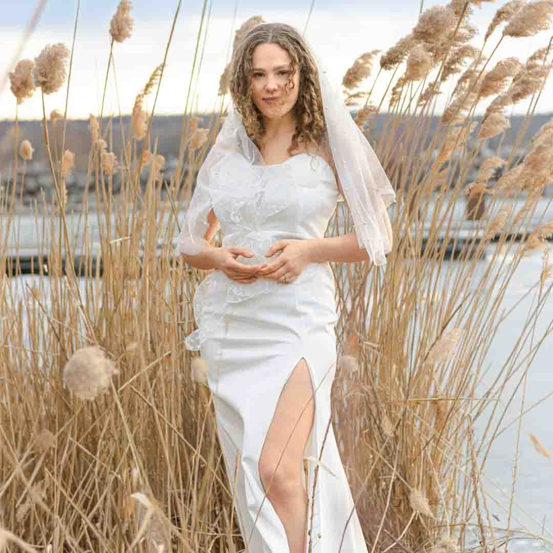 bridal photography standing in the reeds - Bridal portrait. white wedding gown, posed in the reeds with Lake Ontario in the background. bright light and airy photography. Westcott Beach, Alexandria Bay New York