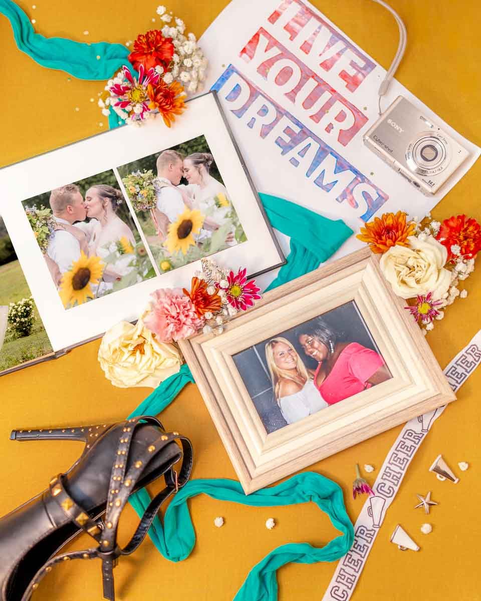 LaDonna Takyi Taylor wedding photography. A personal collage featuring a framed photo of two women, a wedding photo album, a camera, floral decor, and a "Live Your Dreams" sign.