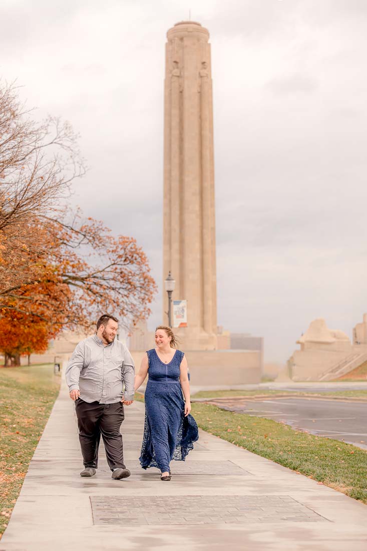 kansas city engagement pictures. Hanna and Shawn walking hand-in-hand near the National WWI Museum in Kansas City.