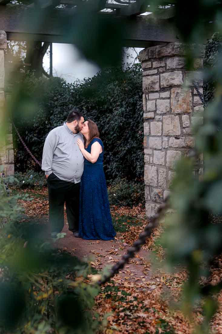 Hanna and Shawn walking near colorful autumn trees during their Kansas City engagement session.