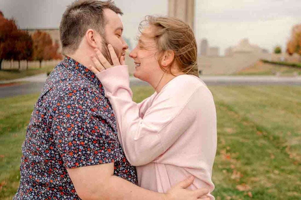 Couple smiling lovingly at each other during their Kansas City engagement session.