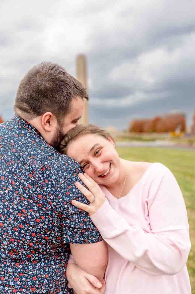 Hanna leaning on Shawn’s shoulder, smiling during their engagement shoot in Kansas City.