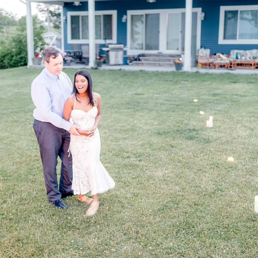 Bride-to-be's joyful reaction after surprise backyard proposal with candles