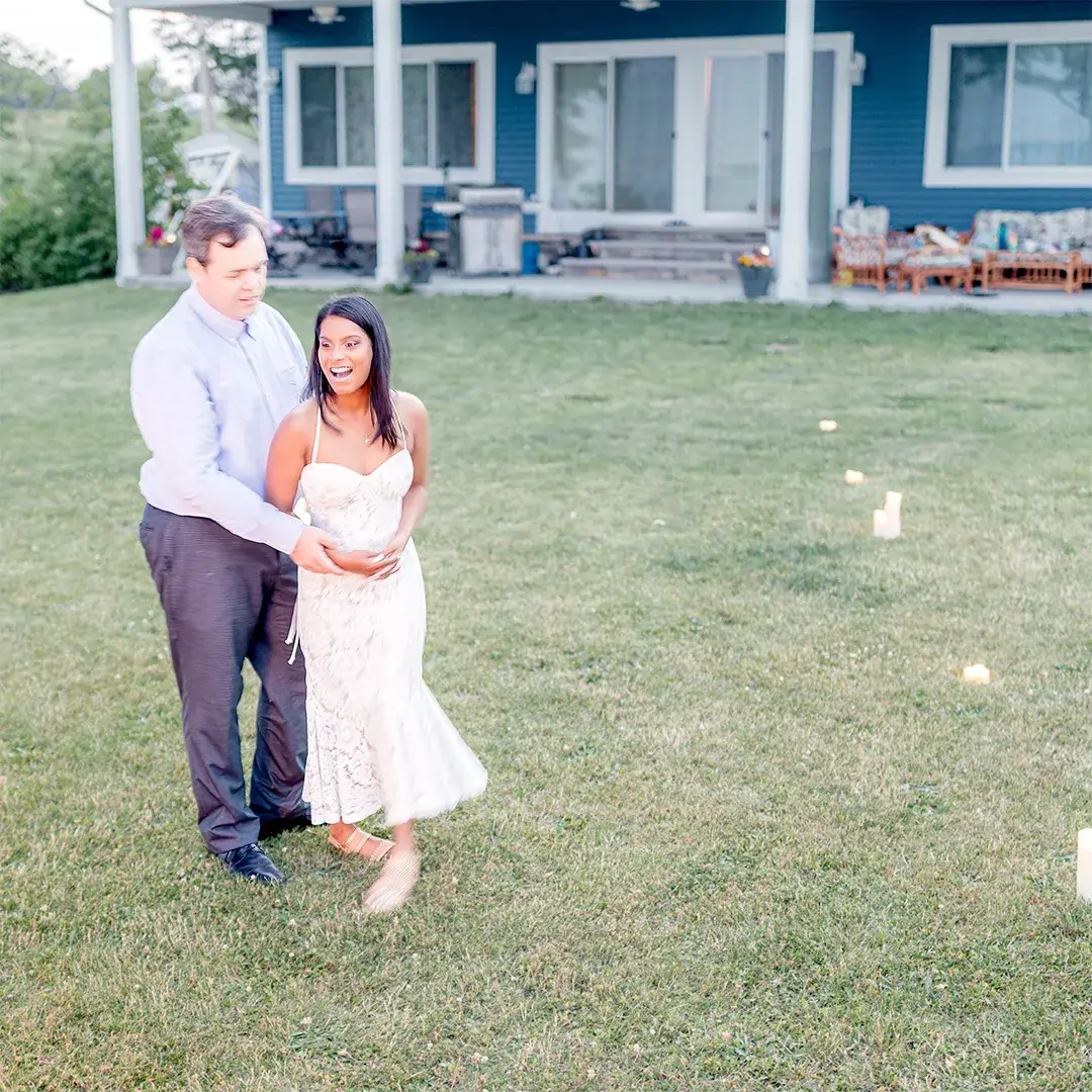 Bride-to-be's joyful reaction after surprise backyard proposal with candles