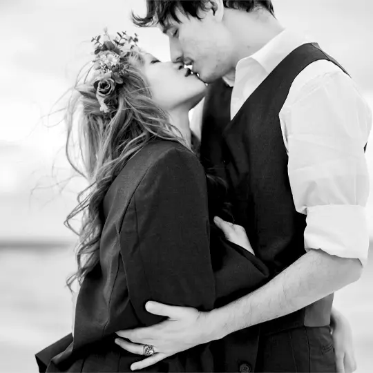 Secret proposal. Artistic black and white beach kiss during Hawaii engagement session