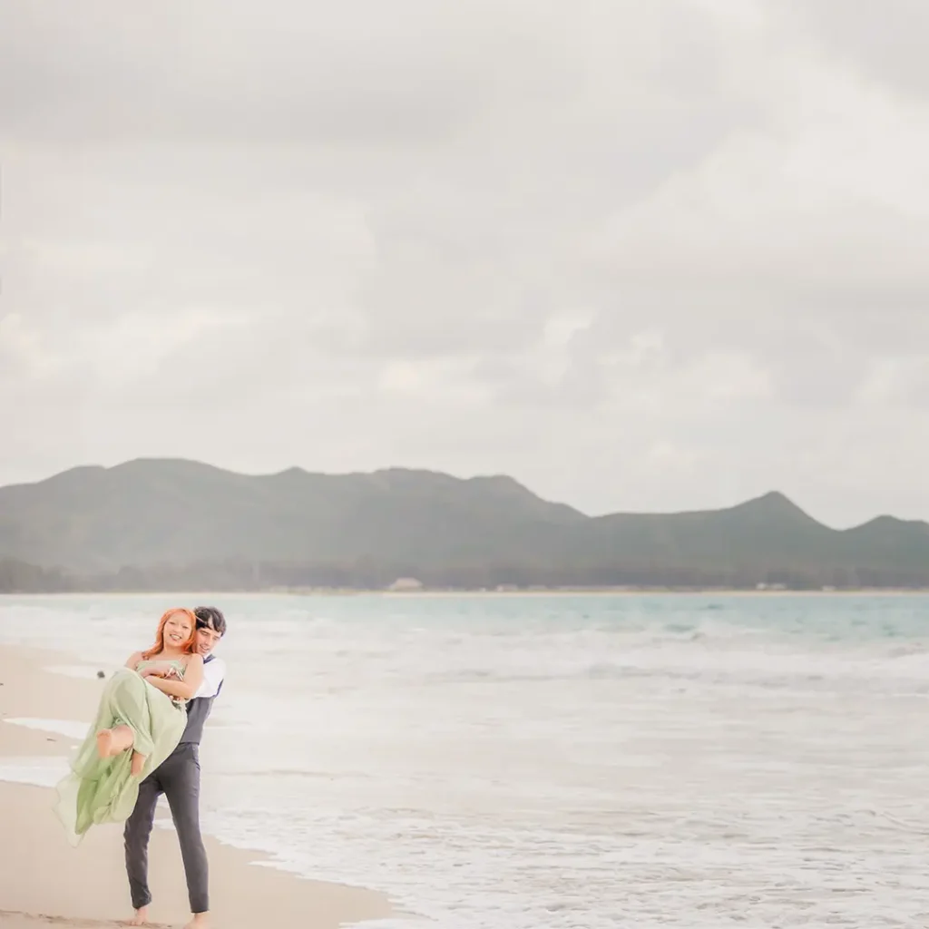 Romantic beach carry during Hawaii engagement session