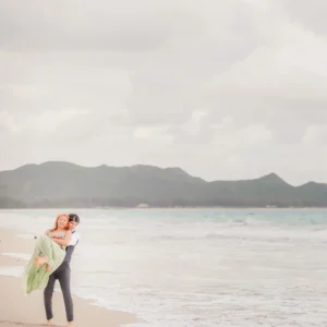 Romantic beach carry during Hawaii engagement session