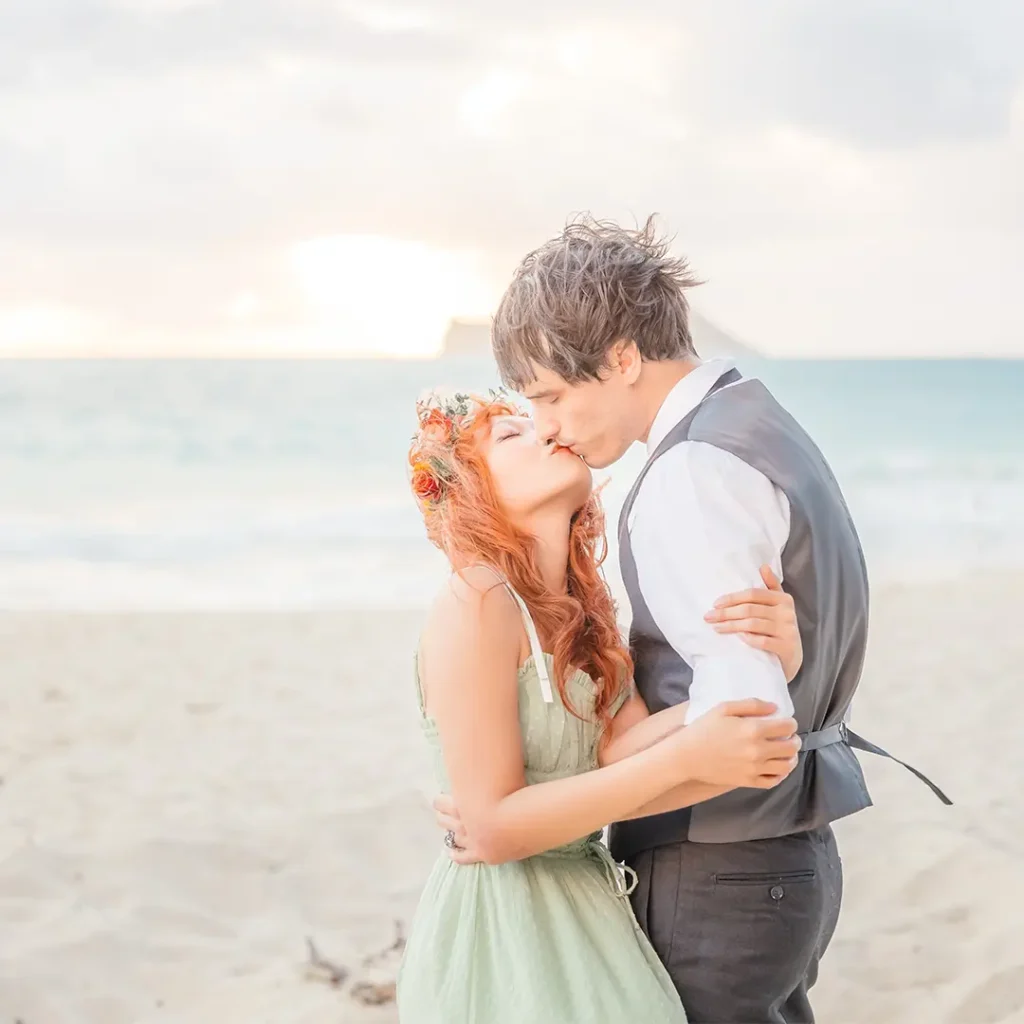 Soft romantic kiss on the beach with floral accents