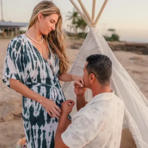 Cheyenne kneels beside a teepee on the beach in Hawaii and gently kisses Loraine’s hand during their emotional proposal recreation.